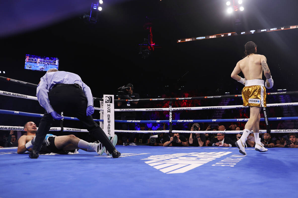 Nico Ali Walsh, right, walks away after knocking out Alejandro Ibarra in the first round of a m ...