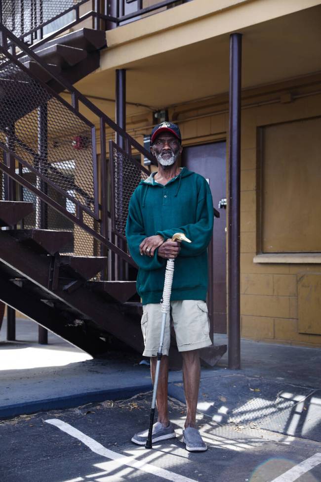 Timothy Thomas, a Marine veteran, walks outside Share Village 4 on Fremont Street, where he has ...