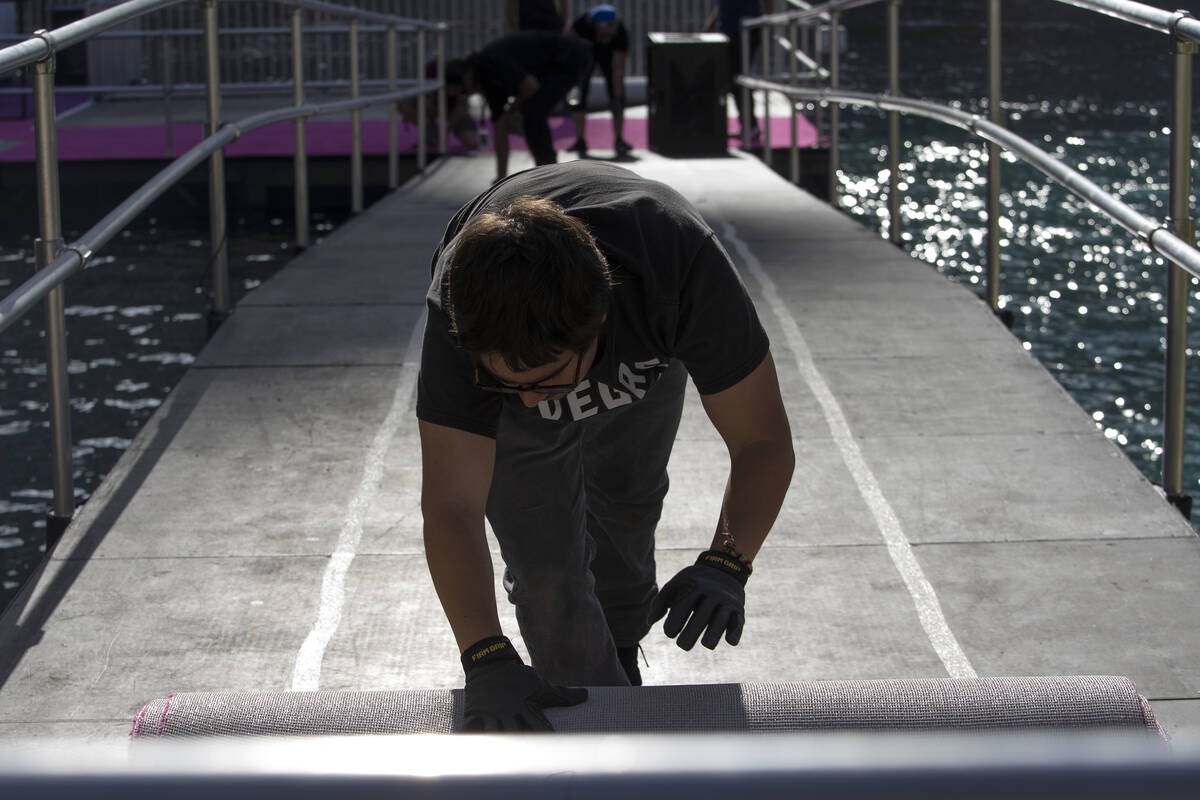 NFL Network crew members dismantle the NFL draft stage in the Bellagio Fountain on Saturday, Ap ...