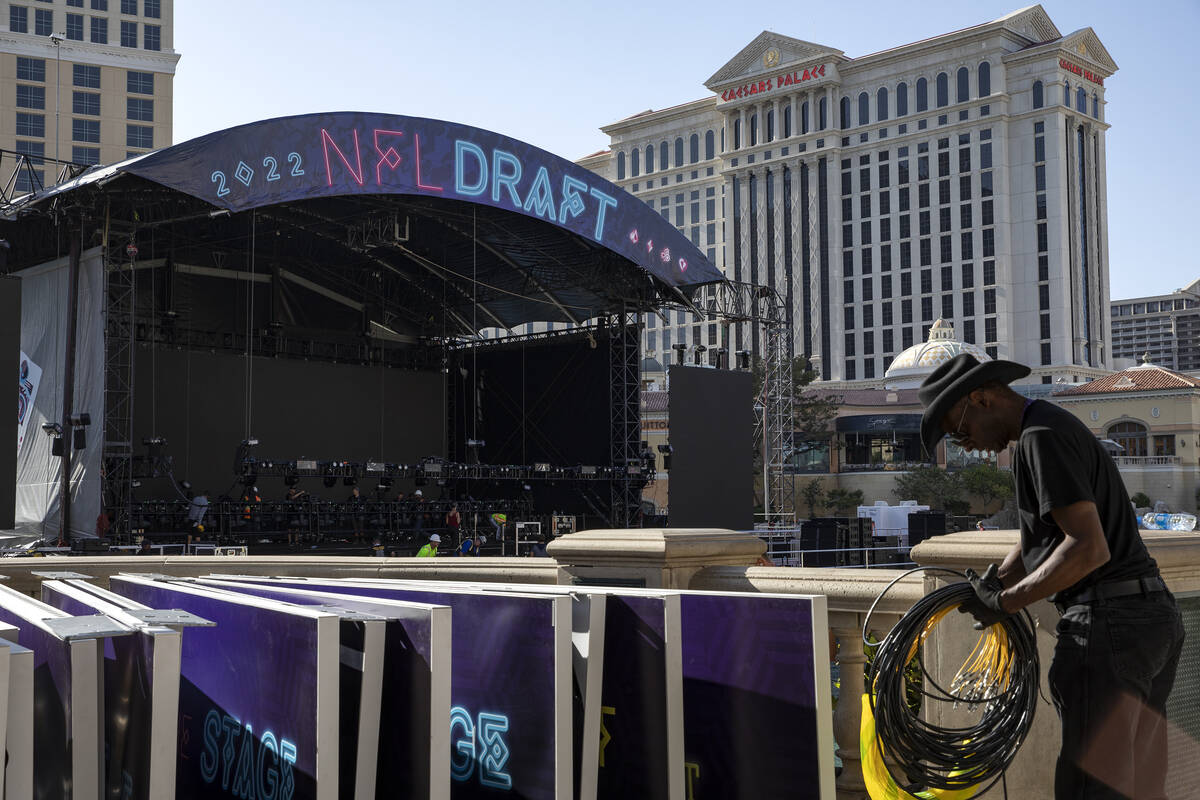 NFL Network crew members dismantle the NFL draft stage in the Bellagio Fountain on Saturday, Ap ...
