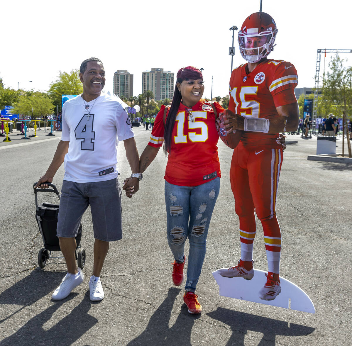 Charles and Delores Burton of Las Vegas walk with a Patrick Mahomes cutout through the Draft Ex ...