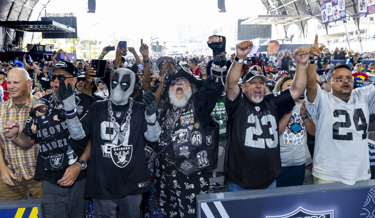 Raiders fans cheer for their team in the Draft Theatre during the third day selections for the ...