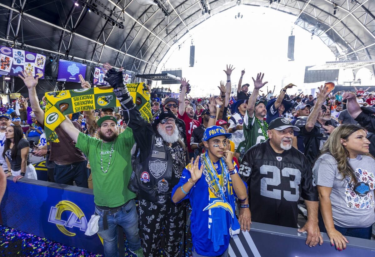 Fans cheer for their teams in the Draft Theatre during the third day selections for the 2022 NF ...