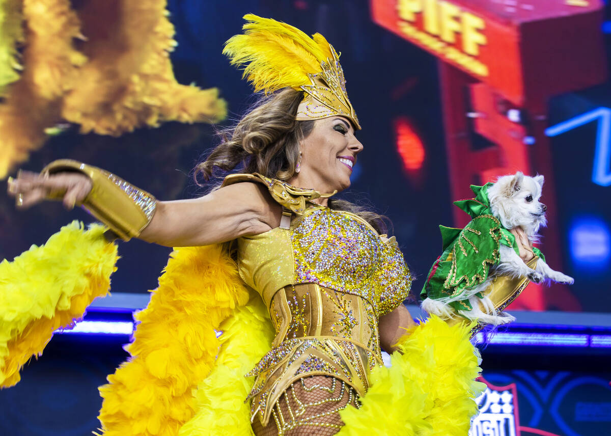 A performer with Piff the Magic Dragon runs across the stage during day three of the NFL draft ...