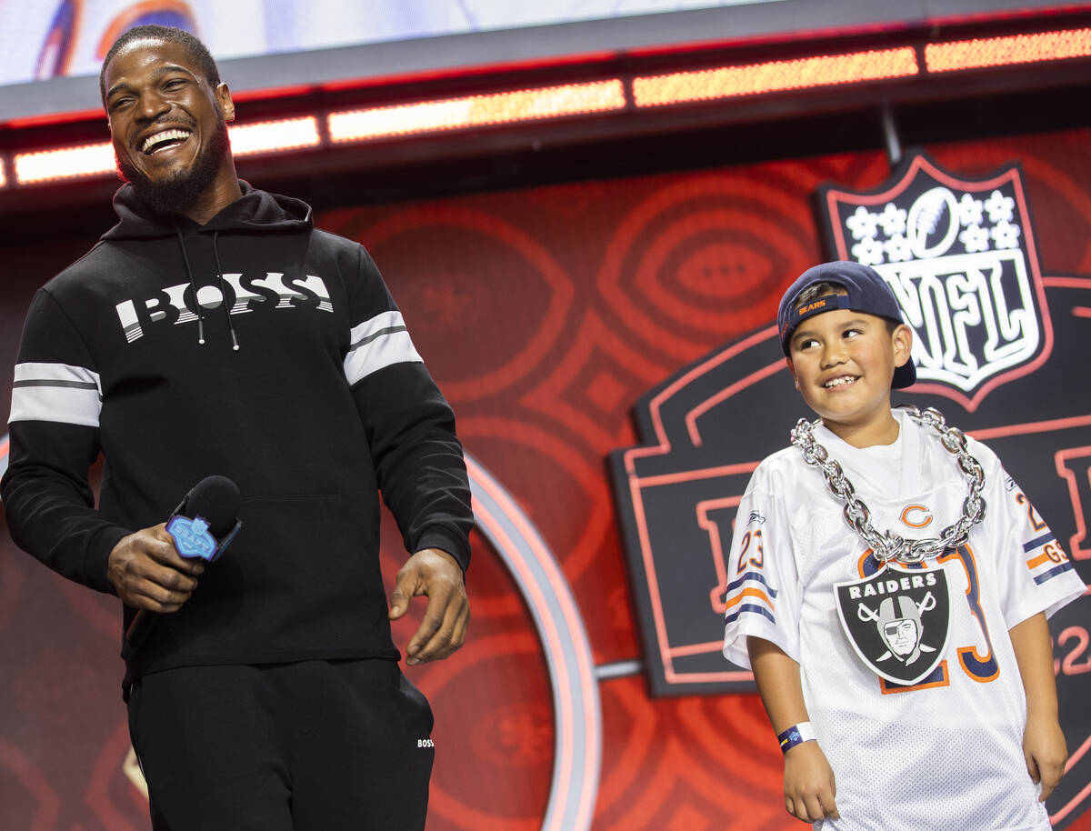 Raiders linebacker Denzel Perryman, left, has fun on stage with a Bears fan during day three of ...