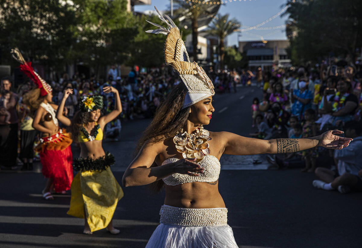 Naenoa George, right, dances during Lei Day, a new parade to celebrate and kick off Asian Pacif ...