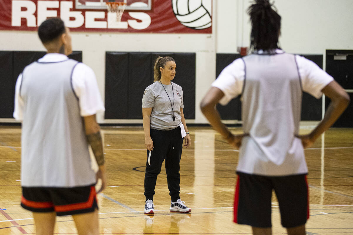 Las Vegas Aces guard Kierstan Bell, left, and forward Mya Hollingshed listen to head coach Beck ...