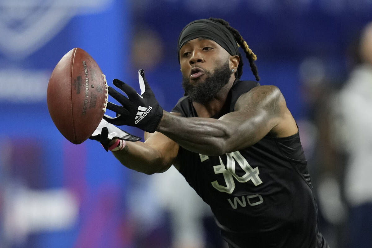 Virginia Tech wide receiver Tré Turner catches a pass during a drill at the NFL football s ...