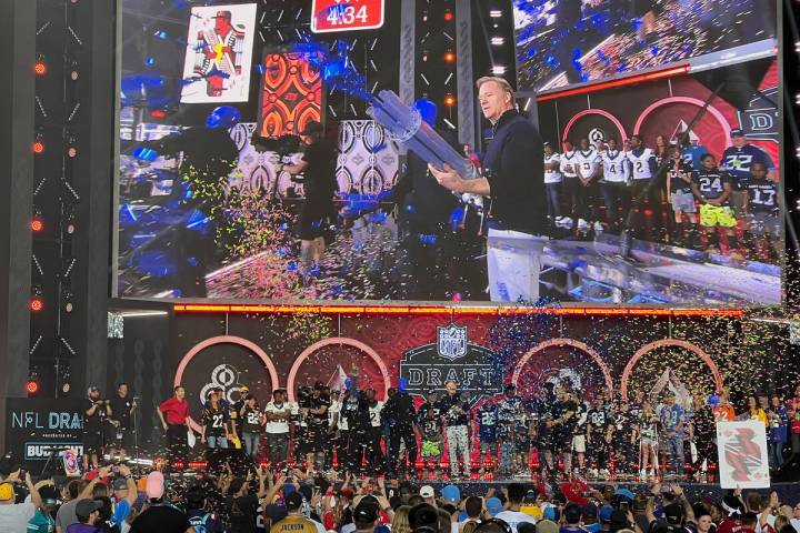 NFL Commissioner Roger Goodell shoots a confetti gun with the Blue Man Group on the main stage ...
