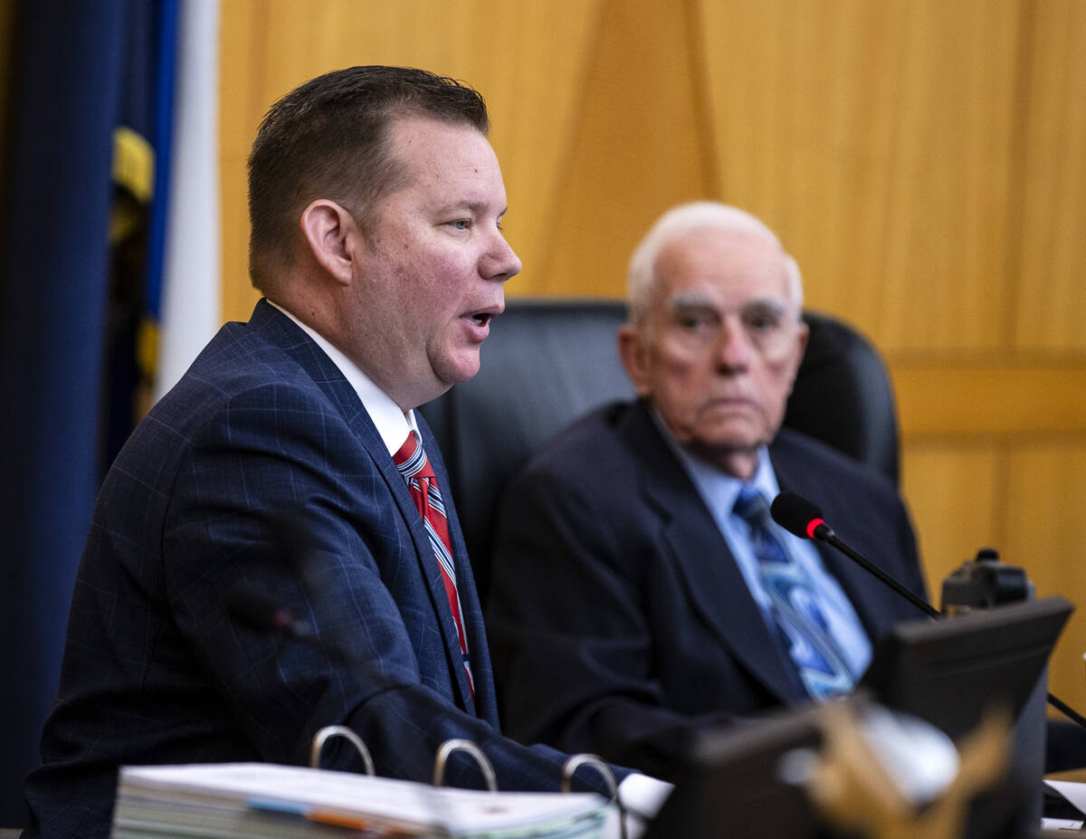 Las Vegas police detective Jason Leavitt, left, testifies as Hearing Officer William Jansen loo ...