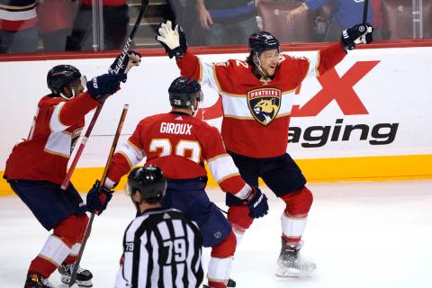 Florida Panthers defenseman Brandon Montour, right, celebrates after scoring in overtime of the ...