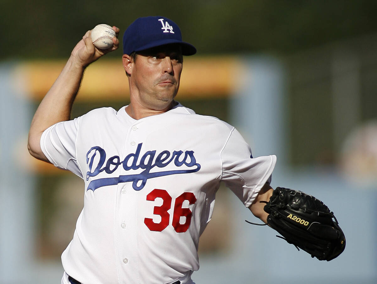 Los Angeles Dodgers' Greg Maddux pitches in the first inning of an MLB baseball game against th ...