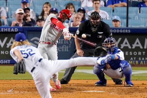 Philadelphia Phillies' Bryce Harper, second from left, hits a solo home run as Los Angeles Dodg ...