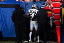 Raiders cornerback Trayvon Mullen (27) is helped off the field into the tent to be assessed for ...