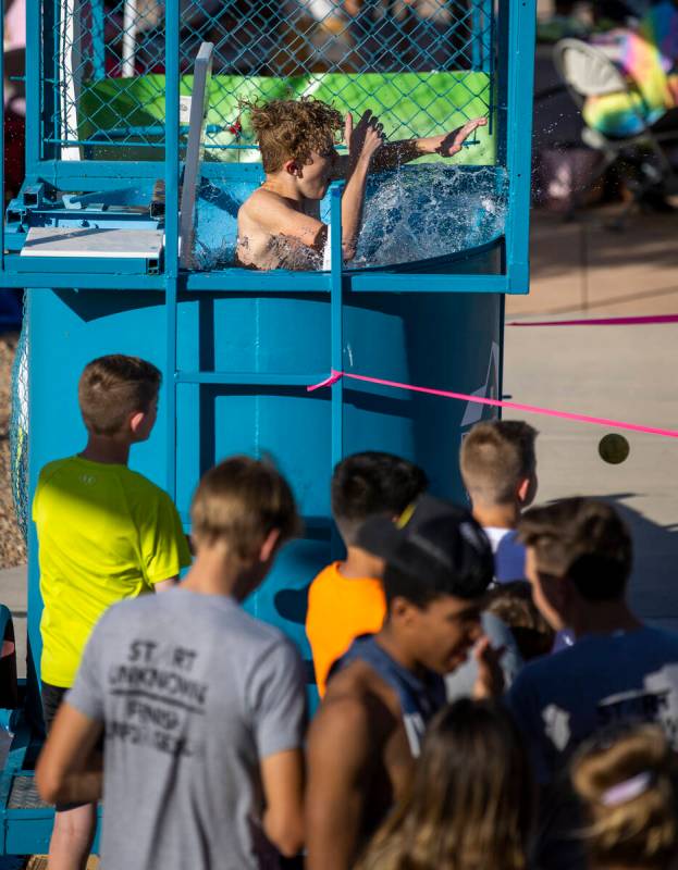 Oliver Lamar, 9, drops into the water while in a dunk tank as part of a celebration of life for ...