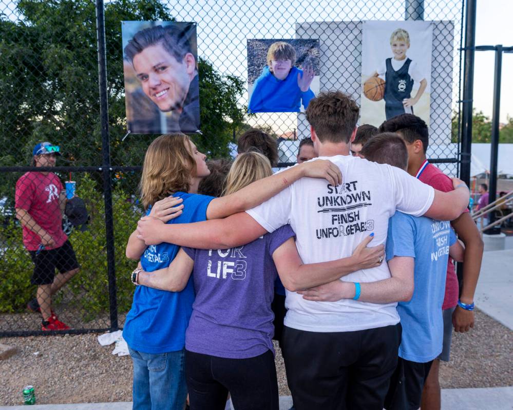 Deedra and Troy Russell have a group hug with their son’s friends during a celebration o ...