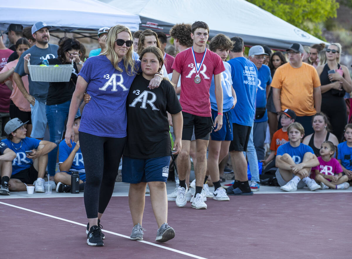 Deedra Russell walks with her daughter Payton as part of a celebration of life for Austen Russe ...