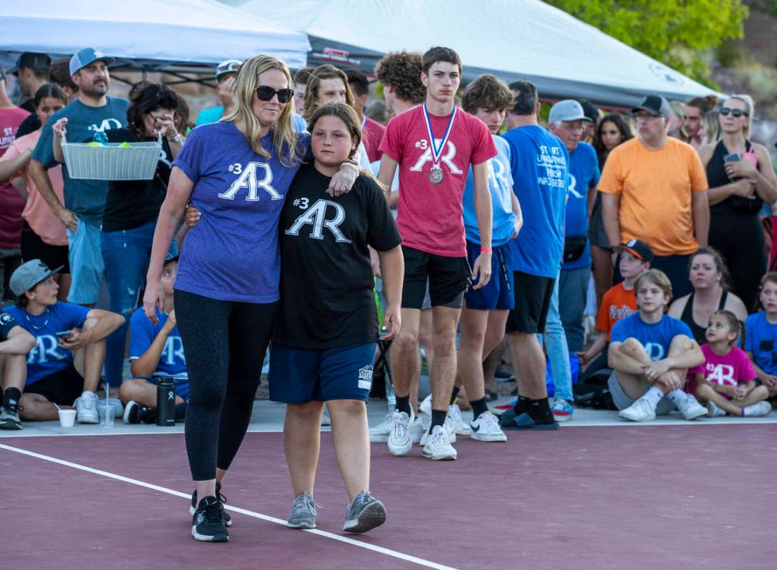 Deedra Russell walks with her daughter Payton as part of a celebration of life for Austen Russe ...