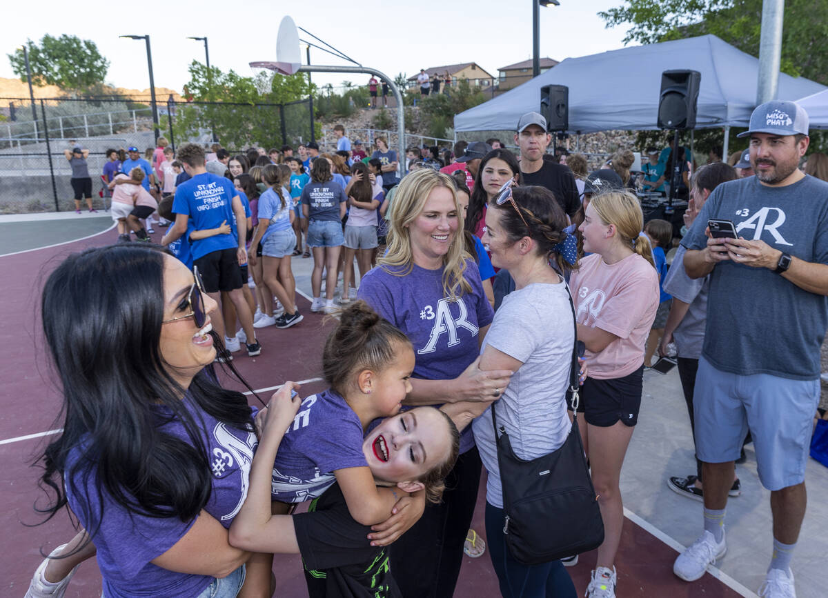 Deedra Russell, center, gets hugs from friends during a celebration of life for Austen Russell, ...