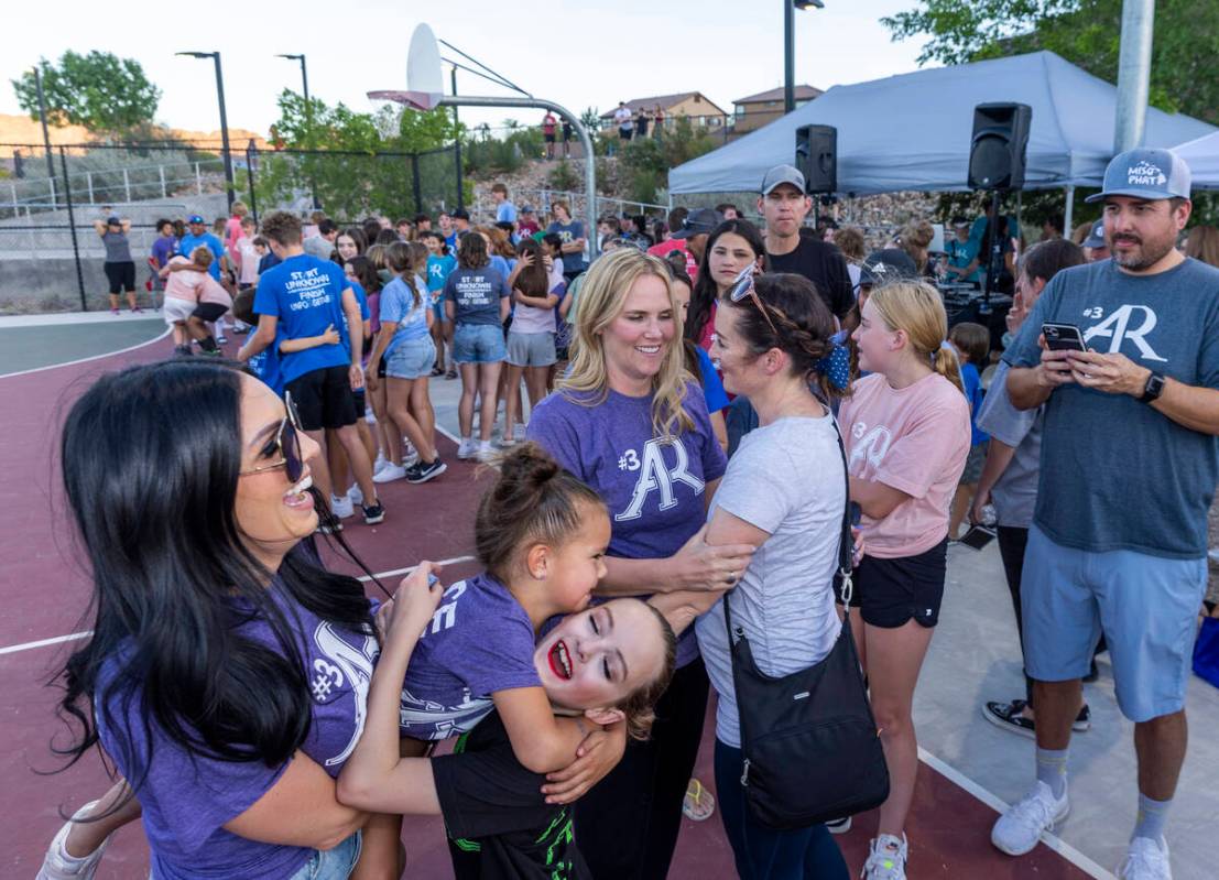 Deedra Russell, center, gets hugs from friends during a celebration of life for Austen Russell, ...