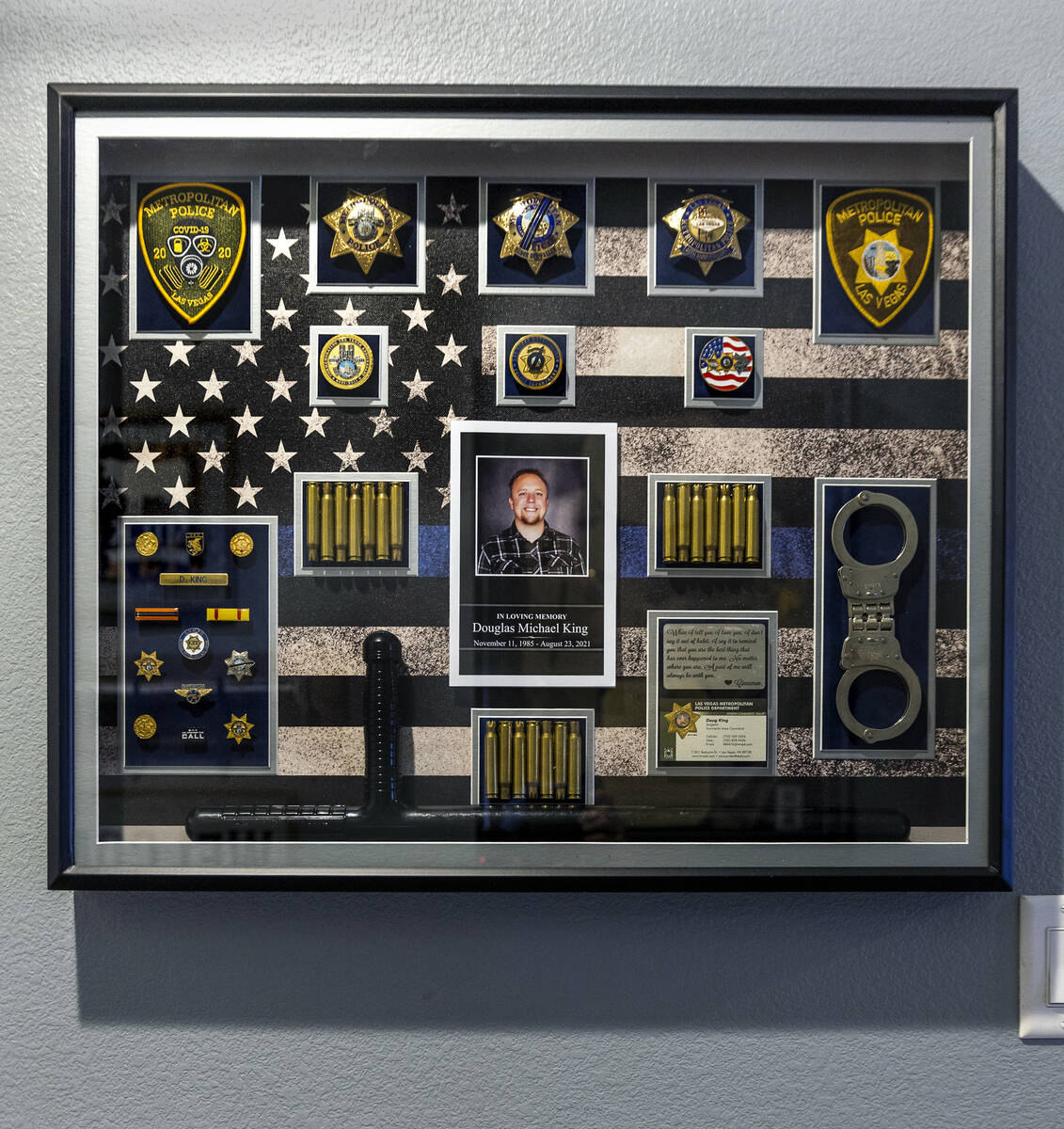 A framed memorial containing police memorabilia from Las Vegas police Sgt. Douglas King picture ...