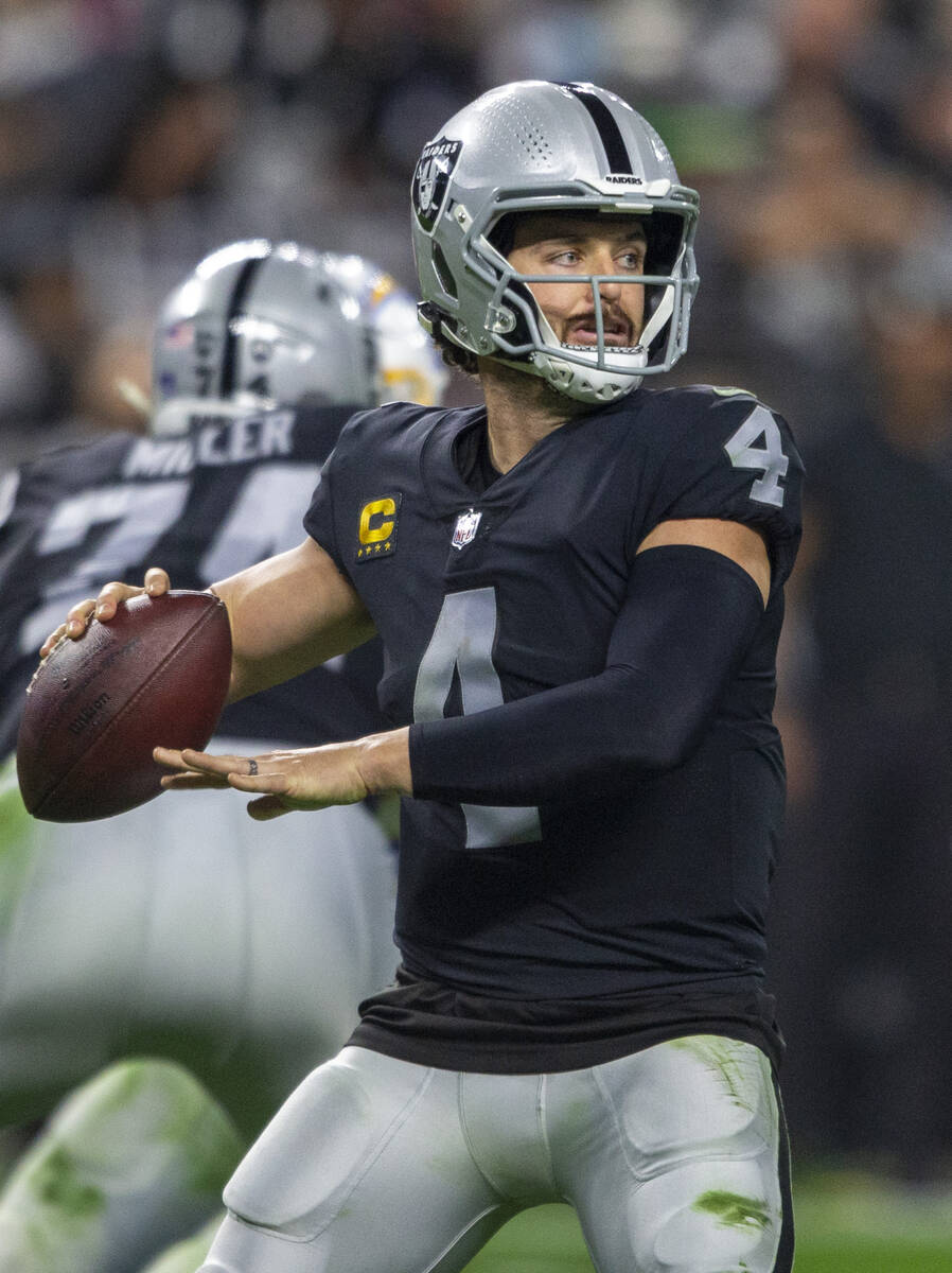 Raiders quarterback Derek Carr (4) prepares to make a throw during the second half of an NFL fo ...