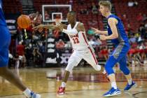 UNLV Rebels guard Josh Baker (22) passes the ball while Air Force Falcons guard Jake Heidbreder ...