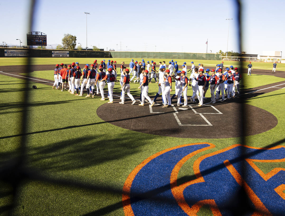 The Bishop Gorman and Coronado High baseball players shake hands after a playoff game at Bishop ...