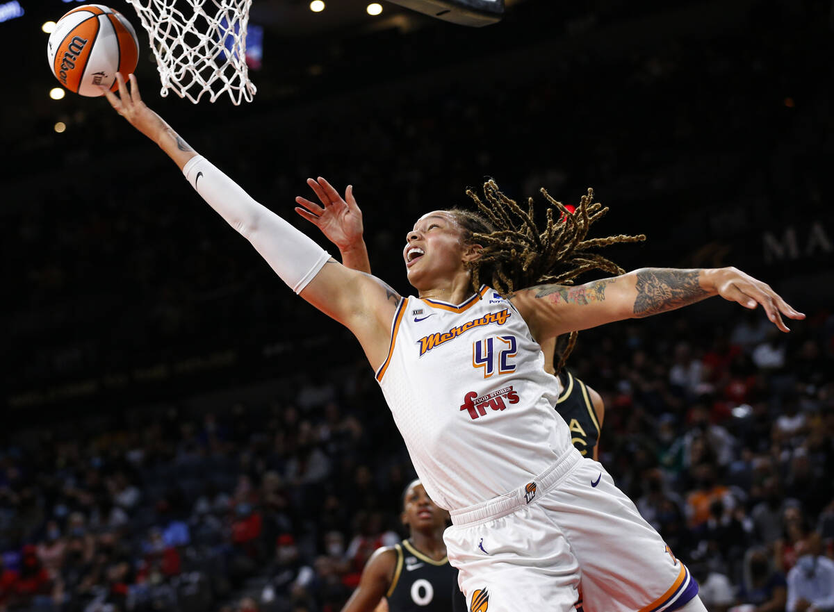 FILE - Phoenix Mercury center Brittney Griner (42) shoots next to Las Vegas Aces center Liz Cam ...