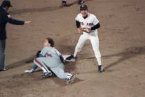 New York Mets Gary Carter, on ground, and Boston Red Sox Marty Barrett react as umpire Ed Monta ...