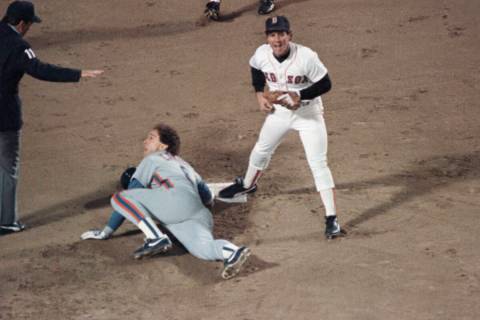 New York Mets Gary Carter, on ground, and Boston Red Sox Marty Barrett react as umpire Ed Monta ...
