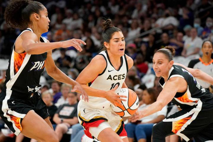 Las Vegas Aces' Kelsey Plum (10) drives to the basket between Phoenix Mercury's Skyler Diggins- ...