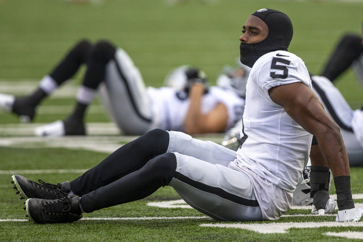 Raiders linebacker Divine Deablo (5) stretches on the field before an NFL playoff game against ...