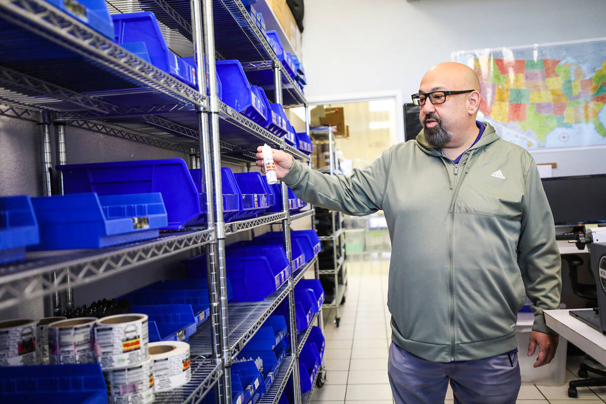 Owner Alex Mazzola holds a flavor of e-liquid he manufactures at Mob Liquid Labs in Las Vegas, ...