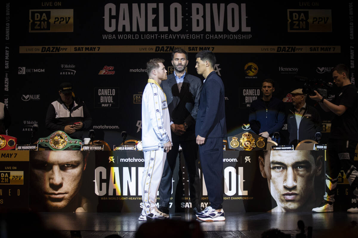 Saul “Canelo” Alvarez, left, and Dmitry Bivol, right, pose during a press confere ...
