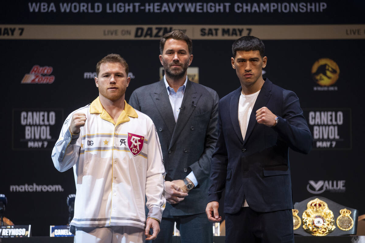 Saul “Canelo” Alvarez, left, and Dmitry Bivol, right, pose during a press confere ...