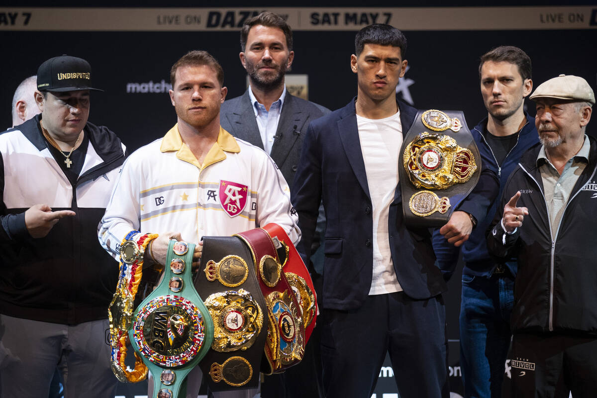 Saul “Canelo” Alvarez, left, and Dmitry Bivol, right, pose during a press confere ...