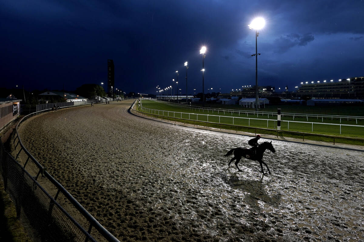 Horses work out in the rain at Churchill Downs Tuesday, May 3, 2022, in Louisville, Ky. The 148 ...