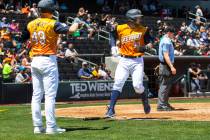 Las Vegas Aviators catcher Shea Langeliers (33) scores a run against the Tacoma Rainiers during ...