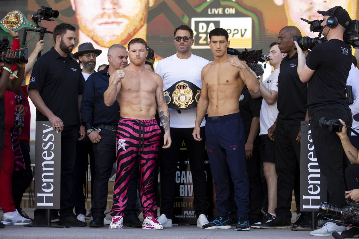 Saul “Canelo” Alvarez, left, and Dmitry Bivol, pose during their ceremonial weigh ...