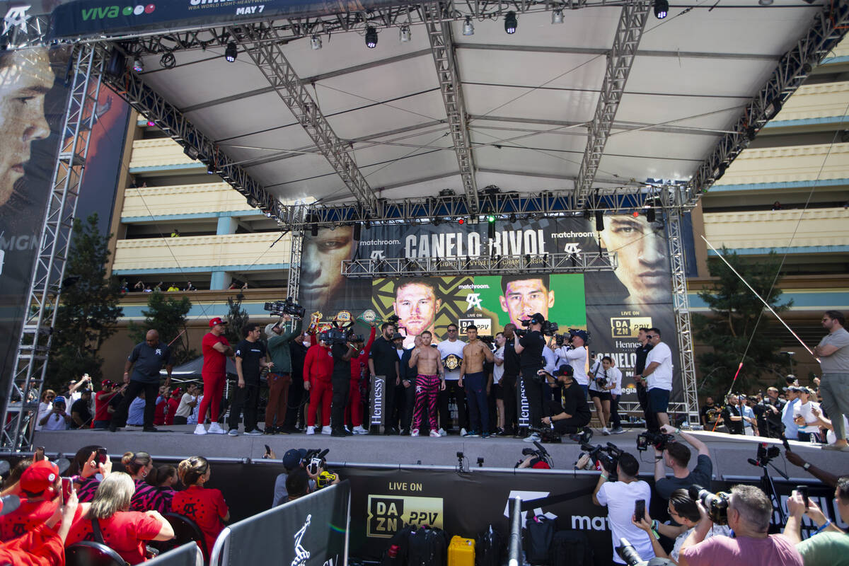 Saul “Canelo” Alvarez, left, and Dmitry Bivol, pose during their ceremonial weigh ...