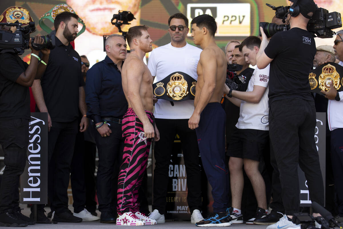 Saul “Canelo” Alvarez, left, and Dmitry Bivol, pose during their ceremonial weigh ...