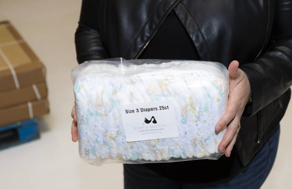 Kelly Maxwell, executive director of Baby's Bounty, shows a package of diapers at the non-profi ...