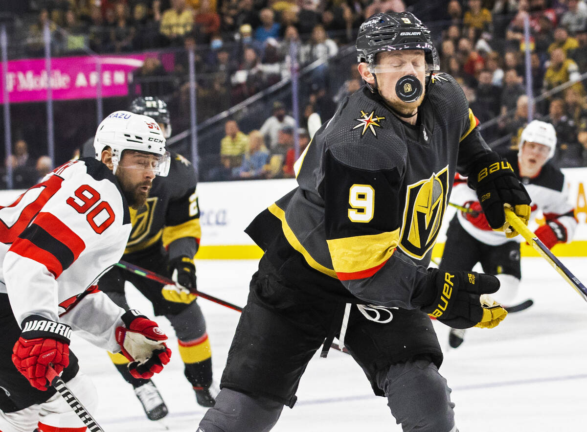 Golden Knights center Jack Eichel (9) takes a puck off the face with New Jersey Devils left win ...