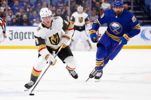 Vegas Golden Knights center Jack Eichel (9) carries the puck past Buffalo Sabres right wing Ale ...