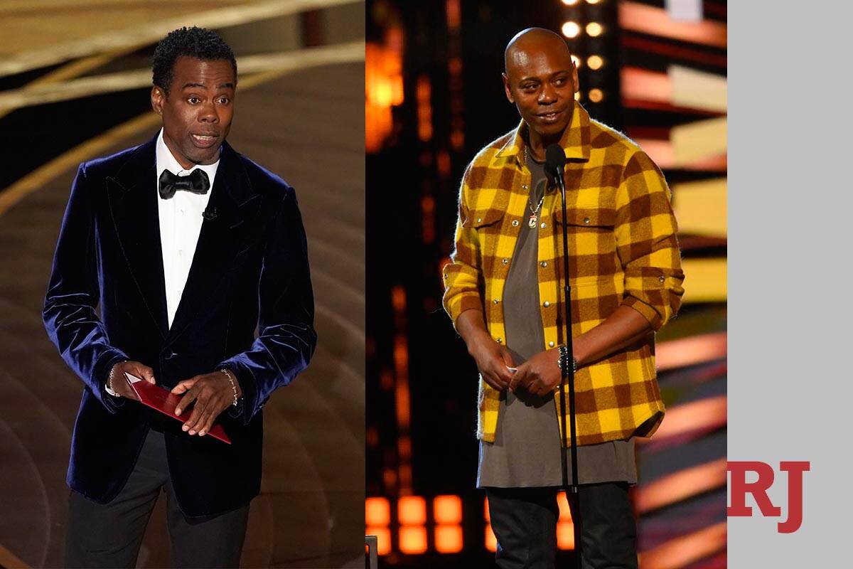 Chris Rock, left, presents an award at the Oscars on Sunday, March 27, 2022, at Dolby Theatre i ...