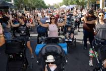 Yoisy Rivera, center, works out with her daughter Lucy, 20 month-old, foreground, during the ni ...