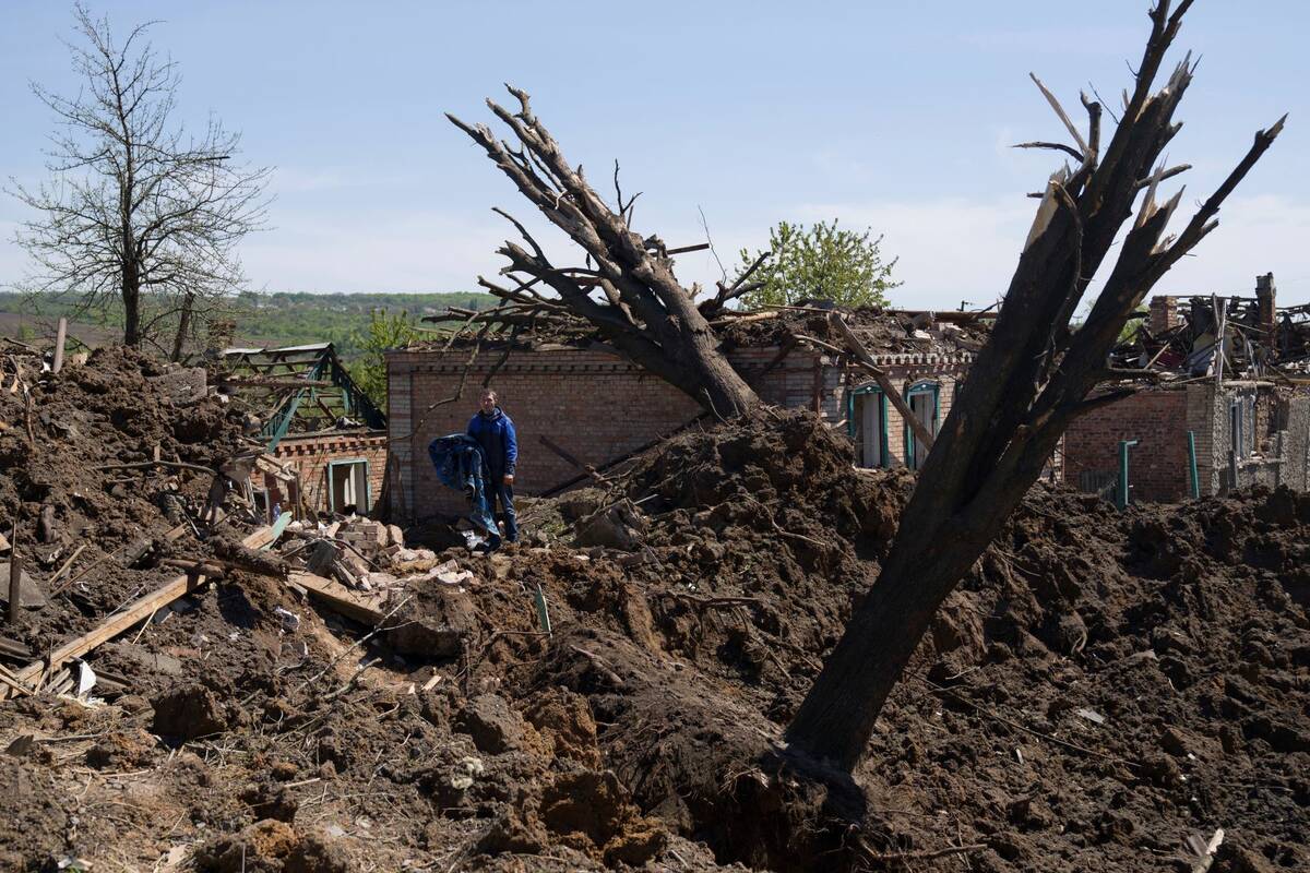 People stand in destroyed residential area after Russian airstrike in Bakhmut, Donetsk region, ...