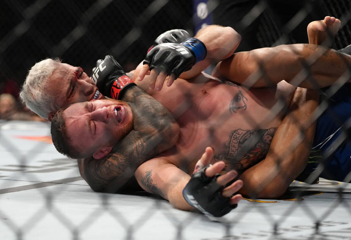 Charles Oliveira of Brazil secures a rear choke submission against Justin Gaethje in the UFC li ...
