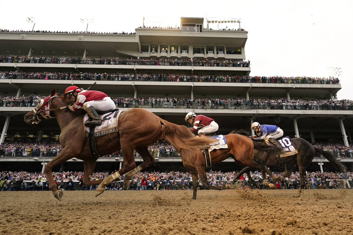 Rich Strike (21), with Sonny Leon aboard, leads Epicenter (3), with Joel Rosario aboard, and Za ...